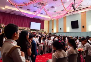 Students celebrating a surprise wedding ceremony in a school auditorium